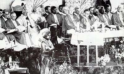 A bare-breasted native woman reads the Epistle in front of John Paul II in Papua New Guinea